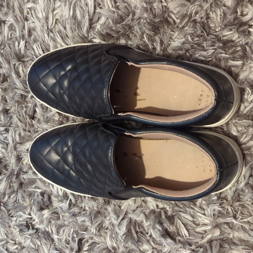 Black quilted slip ons